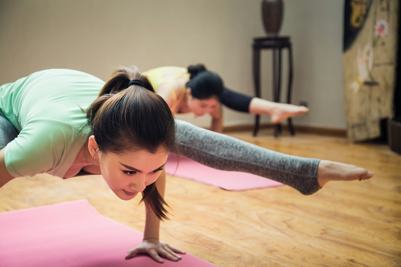 A yoga student stretching toward warm afternoon light in a quiet studio
